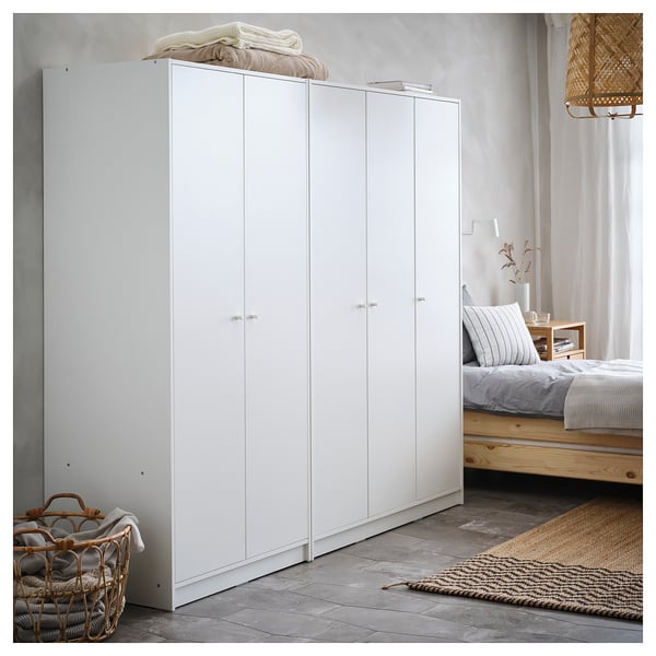 White KLEPPSTAD wardrobe, minimalist design, two-door, wooden texture floor.