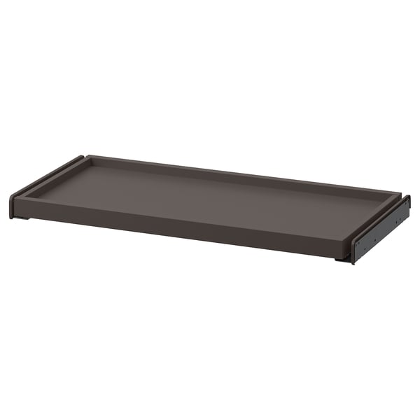 An ikea KOMPLEMENT pull-out tray in dark gray with a sleek, rectangular design, perfect for storing light clothes.