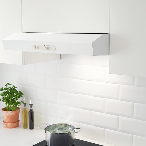 Modern kitchen hood with led light, mounted in cabinet, controlling fan speeds, cooking below.