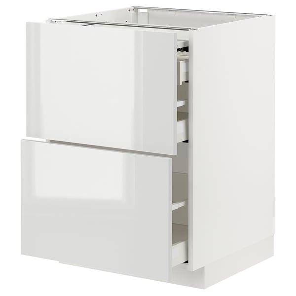 Modern white high-gloss kitchen cabinet with two drawers open, revealing sleek, organized interiors.