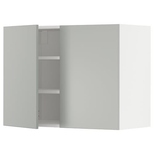 A grey METOD wall kitchen cabinet with two doors open, revealing shelves inside.