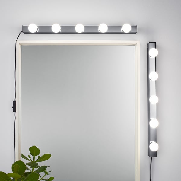 Mirror with horizontal and vertical led lights, ideal for makeup areas. Bright, diffused lighting, adjustable placement.