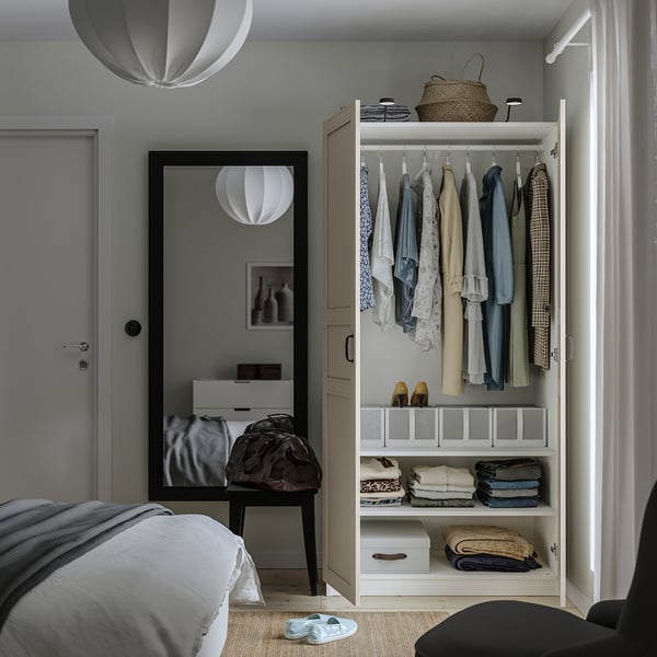 Sleek wardrobe with clothes, shelves, and soft-close hinges.