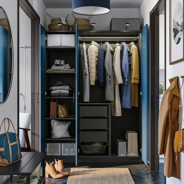 PAX wardrobe with clothes, shelves, and lighting.