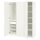 An open white wardrobe named PAX with shelves and mesh baskets for storage.
