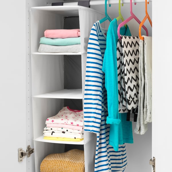 Hanging organiser with 5 compartments, storing coloured clothes, ideal for kids.