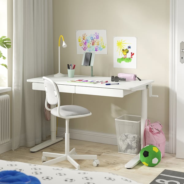 Spacious white desk with adjustable height. Drawers, a tiltable phone holder, and organised storage for kids study essentials.