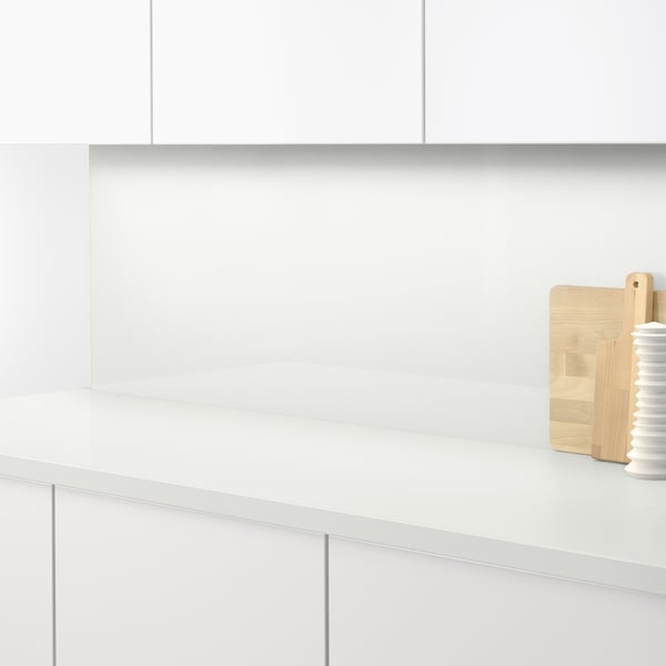 A sleek white kitchen counter with built-in hob, clean and modern. Suitable for easy cleaning and durable against grease.