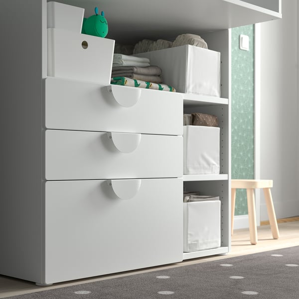Baby changing table with drawers and bins.