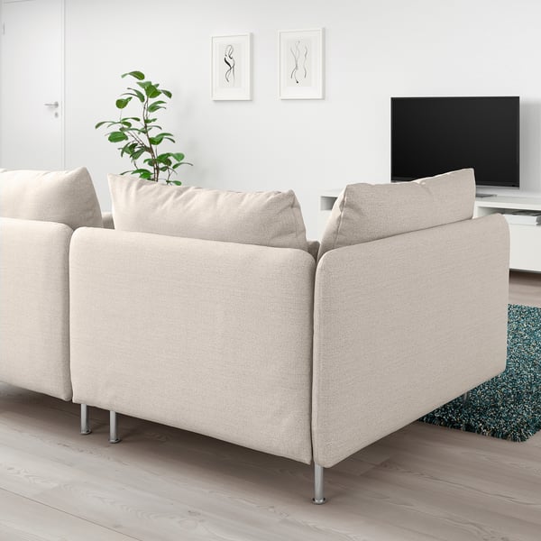 Modern beige SÖDERHAMN sectional sofa, large, in minimalist living room. Accented by green rug and plant.