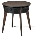 Dark wood round side table with air purifier, three thin legs.