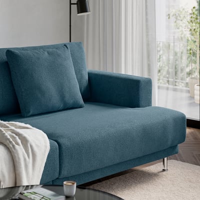 A cosy teal UPPÅKRA sofa with plush cushions and a cup on the table.