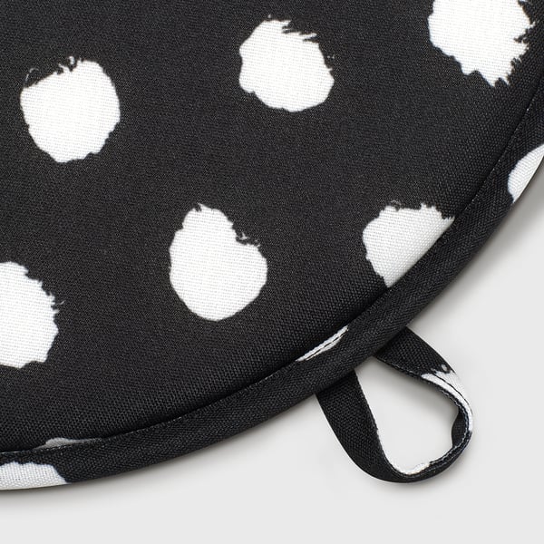 Black and white dotted chair pad with handle for easy carrying or hanging.