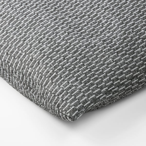 A textured, grey and white fabric, likely from a heating or cooling pad, displaying a soft, woven pattern