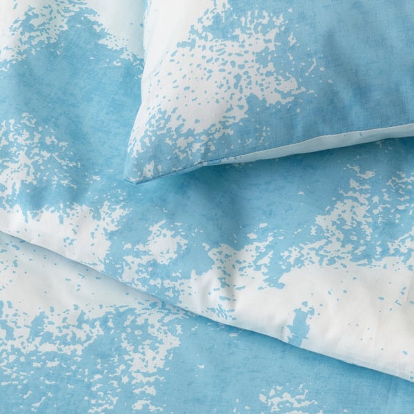 Light blue duvet cover with white cloud pattern, high-quality fabric, neatly hemmed edges.