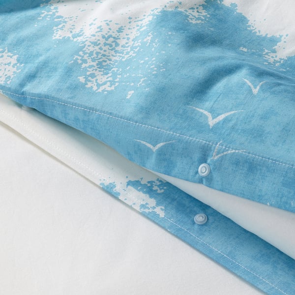 Light blue duvet cover with a sky and clouds pattern, showing high-quality stitching and durable fabric.
