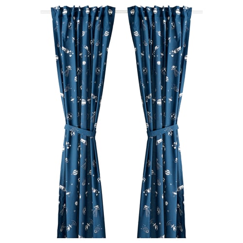 Blue glow-in-dark curtains with space-themed white patterns. Made from recycled polyester and cotton fabric, featuring tab headings and tie-backs.