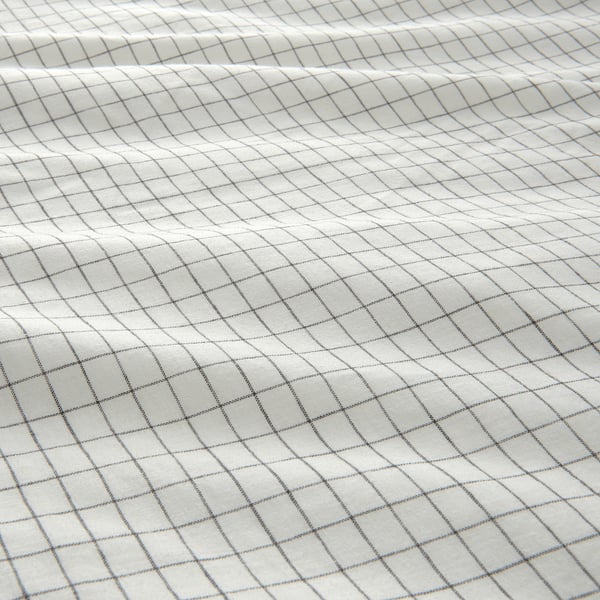 White and light grey grid-patterned bedsheet, made of soft, pre-washed cotton and linen, showcasing subtle wrinkles and natural texture.
