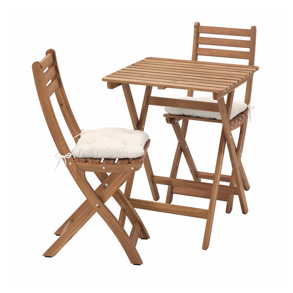 Wooden outdoor table and chairs set with beige cushions.