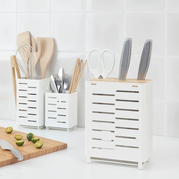 AVSTEG white utensil stand, holding knives, scissors, and spoons. Sleek, modern design, fitting in small spaces, with a draining tray inside.