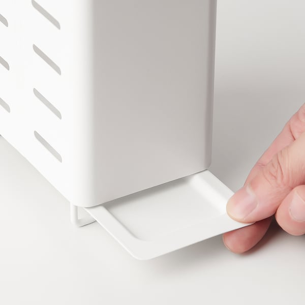 Hand pulls tray from cutlery drainer