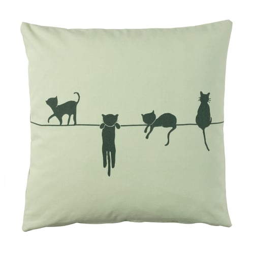 Greenish square pillow with black cat silhouettes walking on a line.