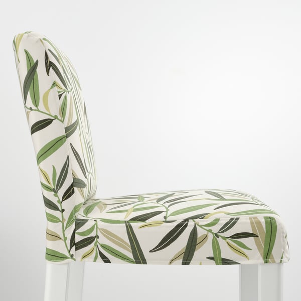 White bar stool with tropical leaf print fabric. Upholstered seat and back, sleek white legs, stylish and comfortable.