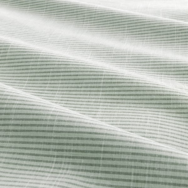 Textured close-up of cotton fabric with subtle green stripes, showcasing quality craftsmanship.