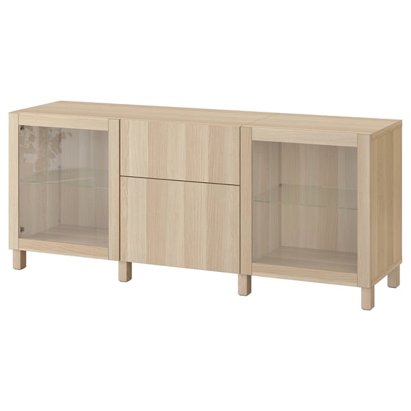 Ikea BESTÅ light brown wooden storage unit with glass doors and drawers.