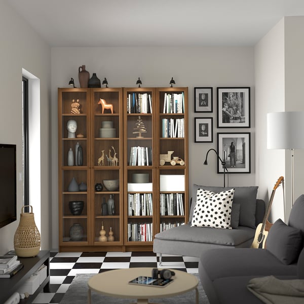 Cosy living room with BILLY bookshelf focal point, books, decor, grey couch, chequered floor, and personal touches.