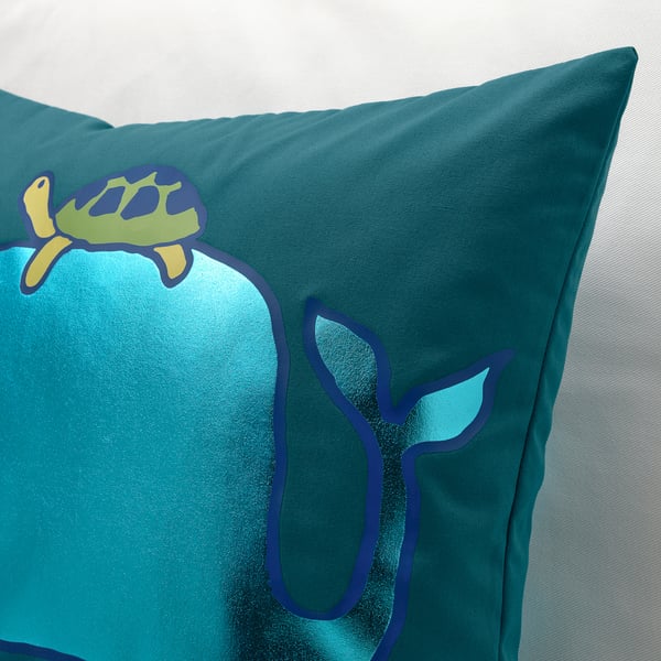 Teal pillow with whale and turtle designs, made from recycled polyester.