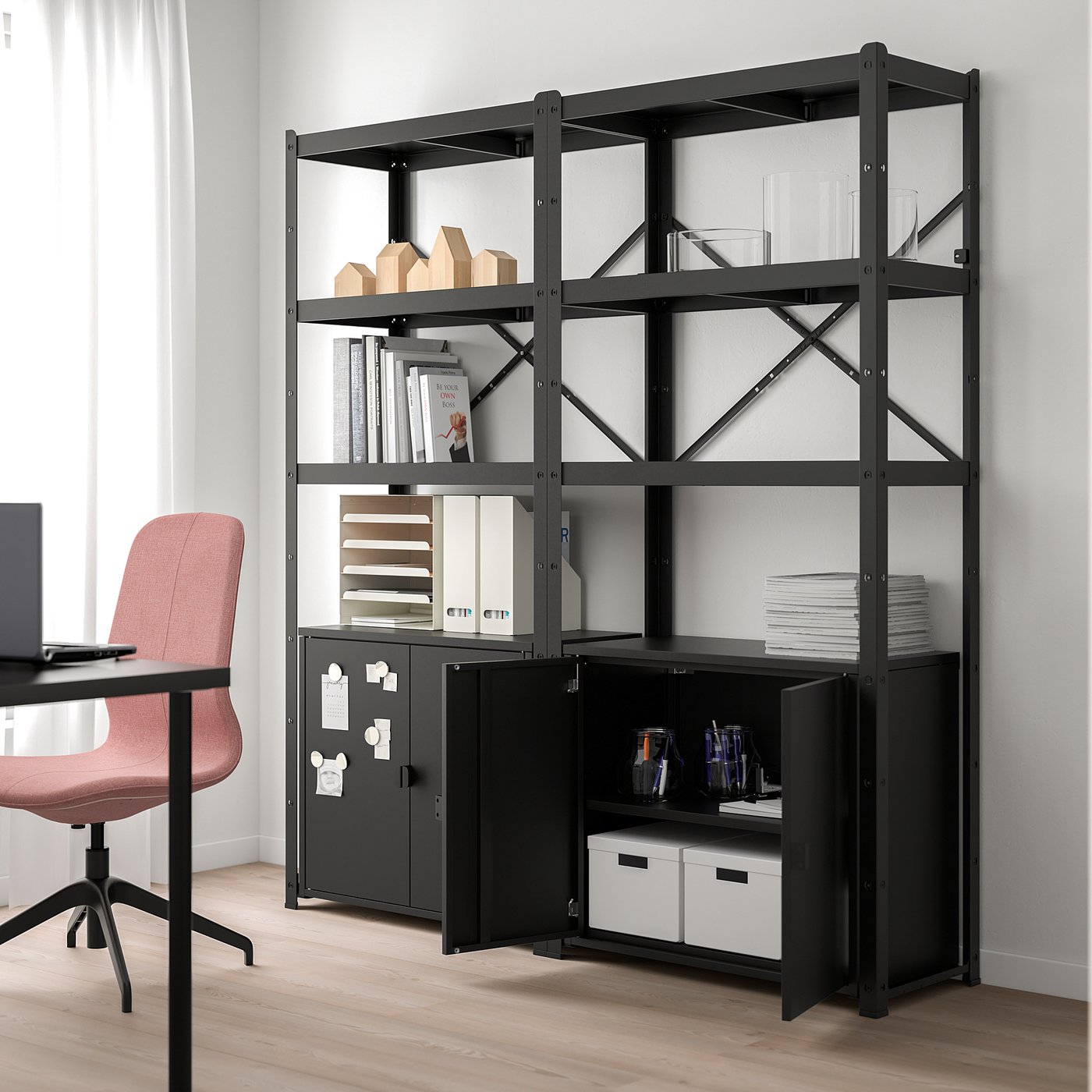 Black BROR storage unit with shelves and cabinet, holding books and boxes, nearly reaching the ceiling.