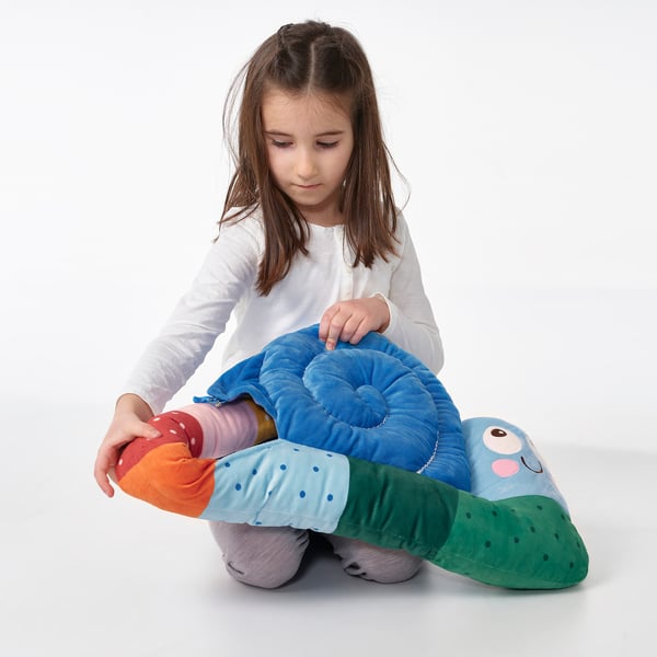Girl with BRUMMIG blue snail cushion.