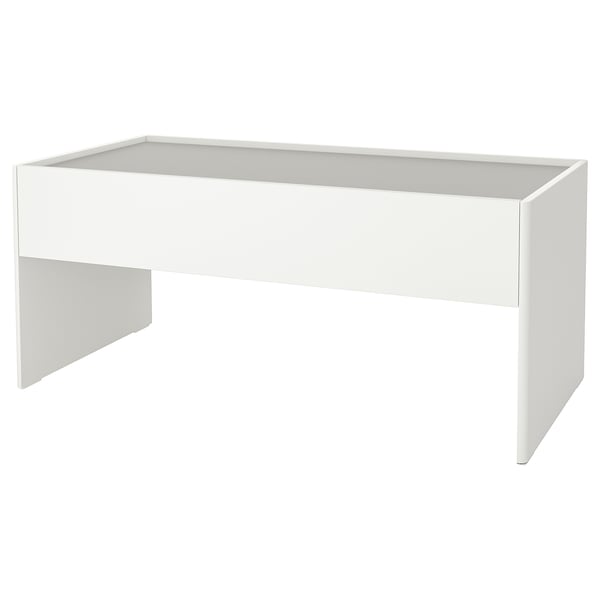 A white DUNDRA childrens activity table with a rectangular shape and smooth design. It a large, flat top and a central drawer for storage.