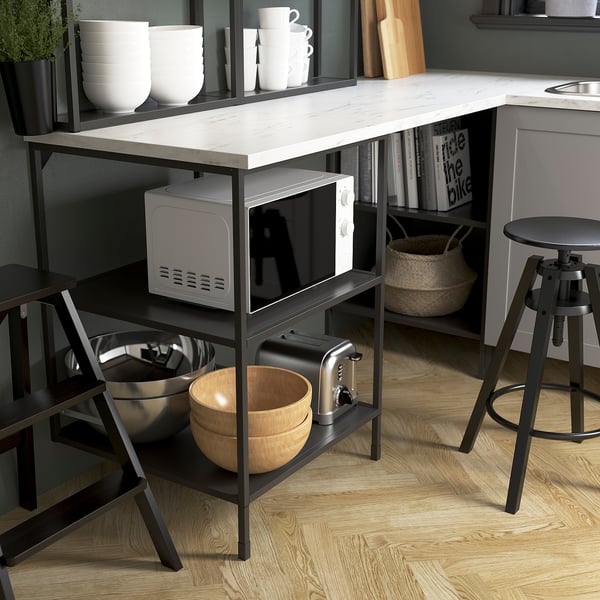 Small kitchen island with microwave, toaster, bowls, and cups. ENHET series style.