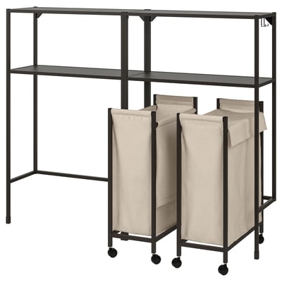Black metal storage unit with shelves and beige beige laundry bags on wheels.
