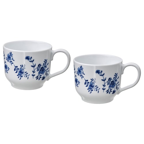 Two white porcelain mugs with blue floral designs, round shape, and handles. Ideal for tea or coffee.
