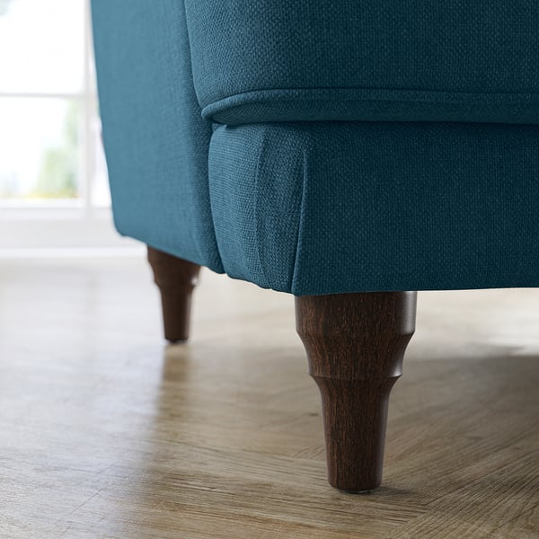 Teal fabric sofa, curved legs. Soft, inviting design.