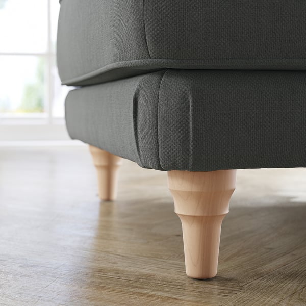 Close-up of grey ESSEBODA footstool with wooden legs on wooden floor.