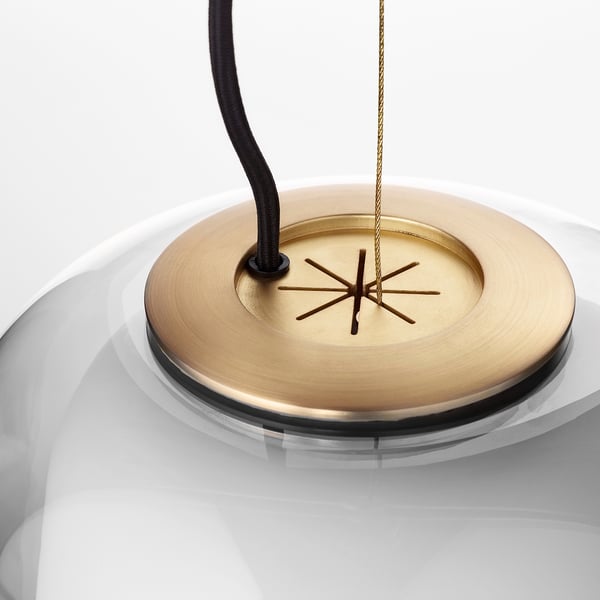 Gold-toned ceiling lamp with intricate design, hanging cord, and sleek materials.