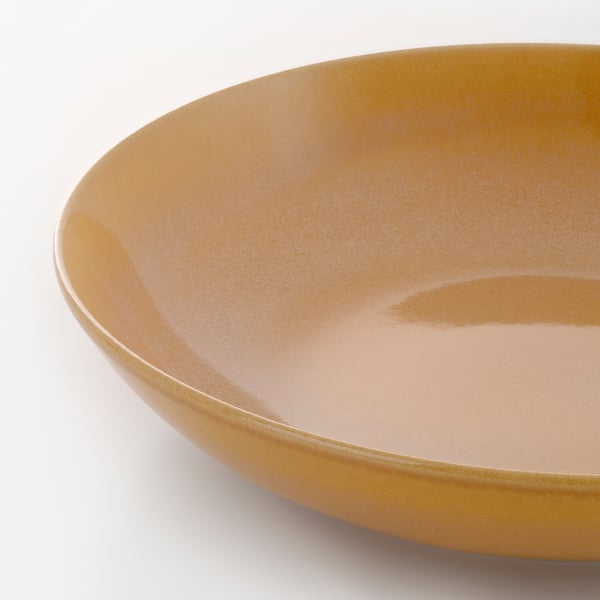 Rustic stoneware plate with textured, glossy finish; simple, deep design.