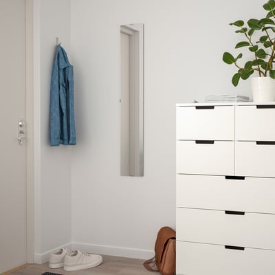 Small white door mirror, FREBRO, vertical, between hook with blue jacket and white dresser.