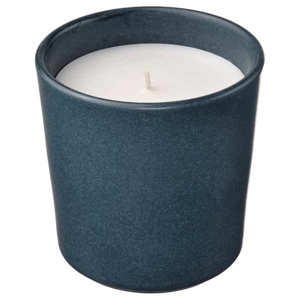 Blue ceramic candleholder with white candle, rustic, cosy decor.
