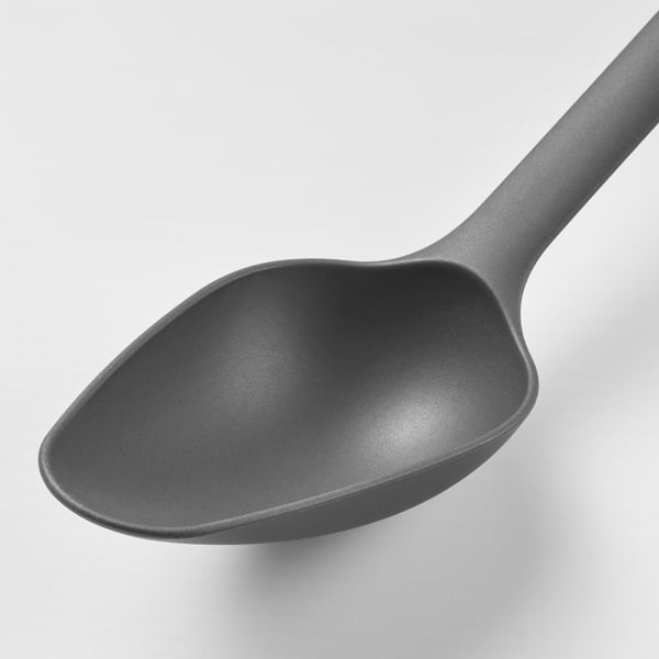 A single black spoon with a smooth, non-stick coated surface and a sturdy handle.