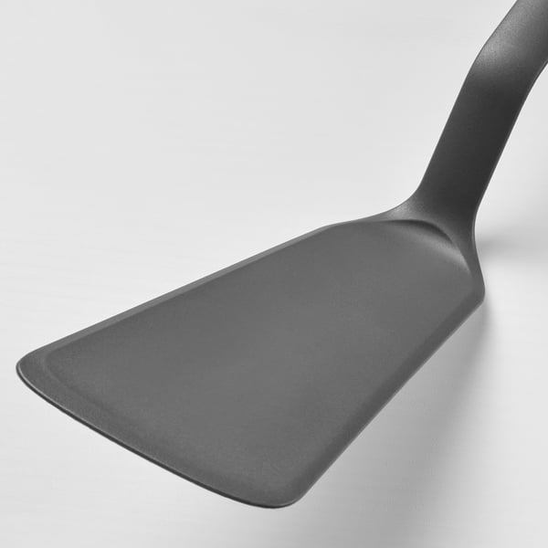 Dark grey, sturdy spatula with smooth edge and comfortable handle, ideal for non-stick cookware.