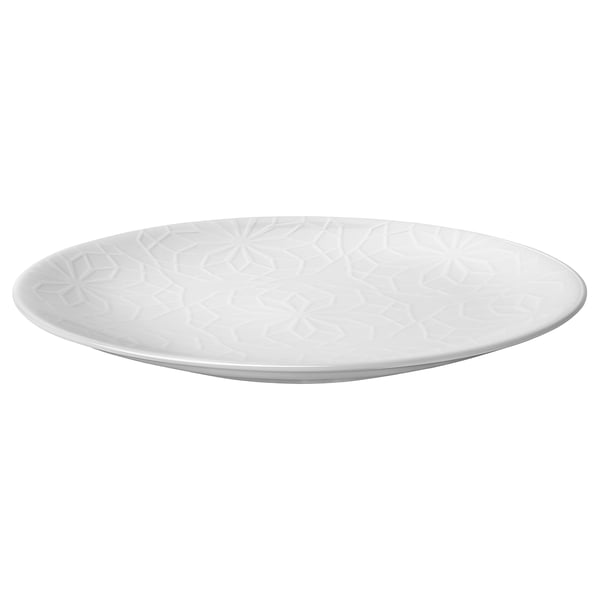A white GOKVÄLLÅ side plate. Its circular, with an embossed geometric pattern, and made of durable porcelain.
