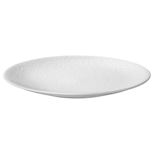 A white GOKVÄLLÅ side plate. Its circular, with an embossed geometric pattern, and made of durable porcelain.