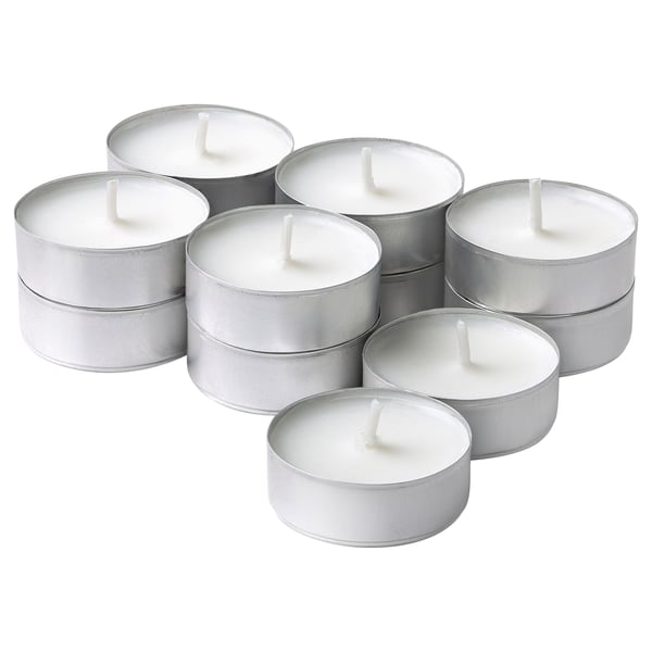 Six silver tealights, cylindrical with wicks, arranged in a circular pattern, gleaming metal reflecting light.