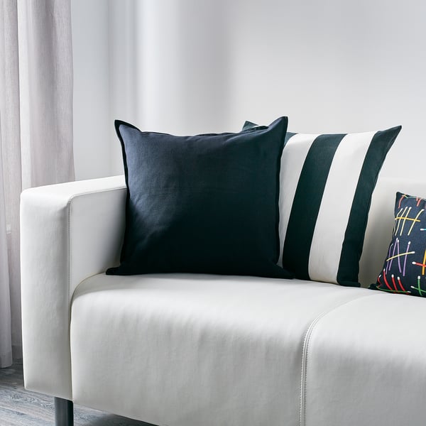 Navy blue GURLI cushion on white couch, square, cotton, elegant.