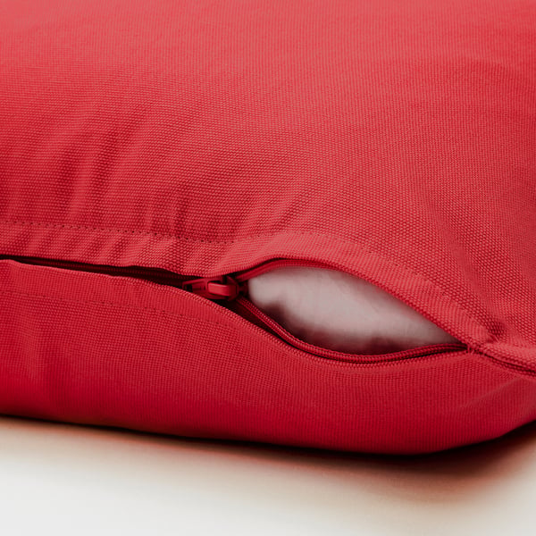 Red cushion cover with zip for easy removal.